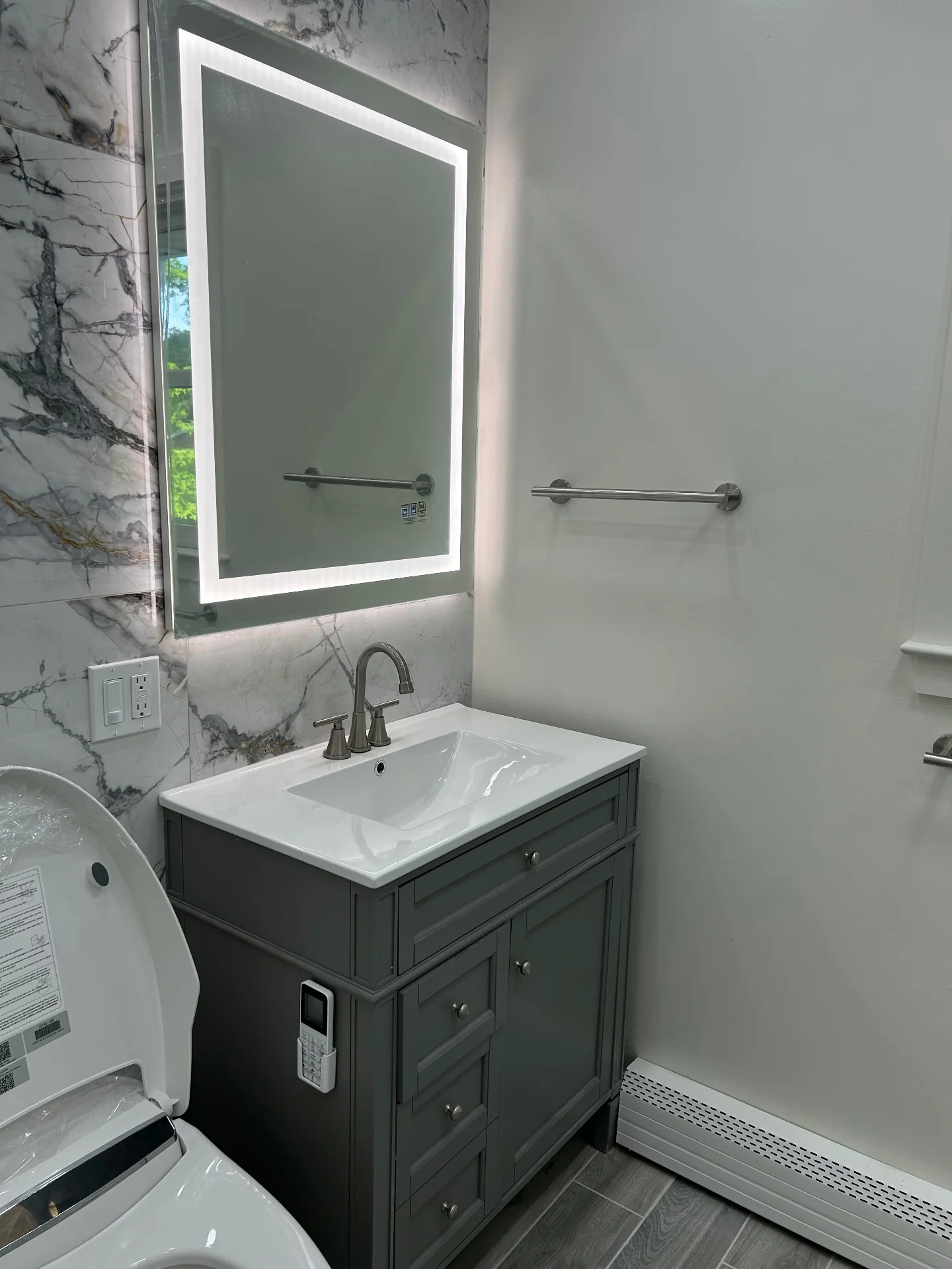 Luxury spa bathroom renovation with heated floors and frameless glass shower in North Bergen NJ