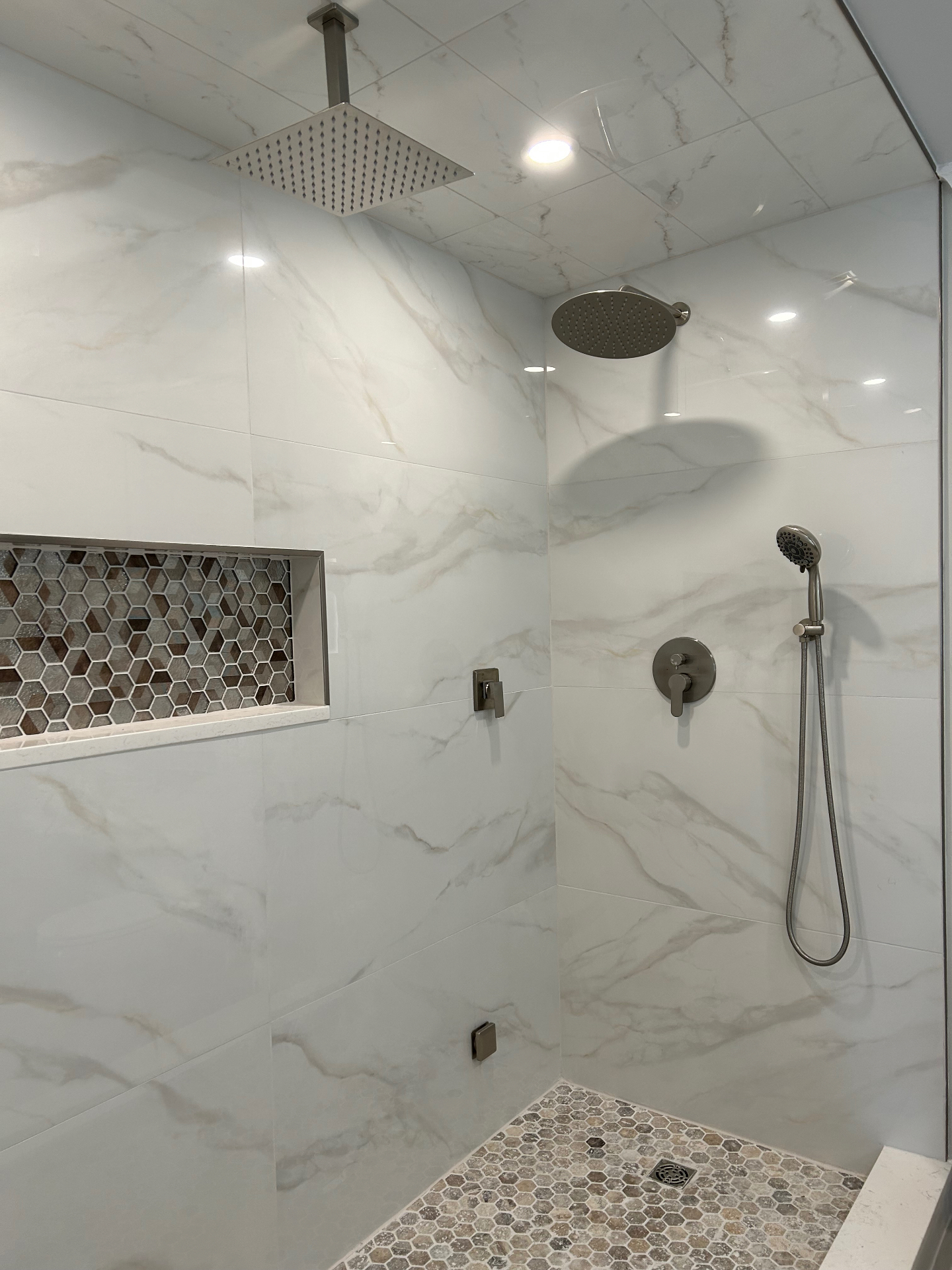 Custom marble walk-in shower with frameless glass in luxury master bathroom renovation NJ by Strong Construction