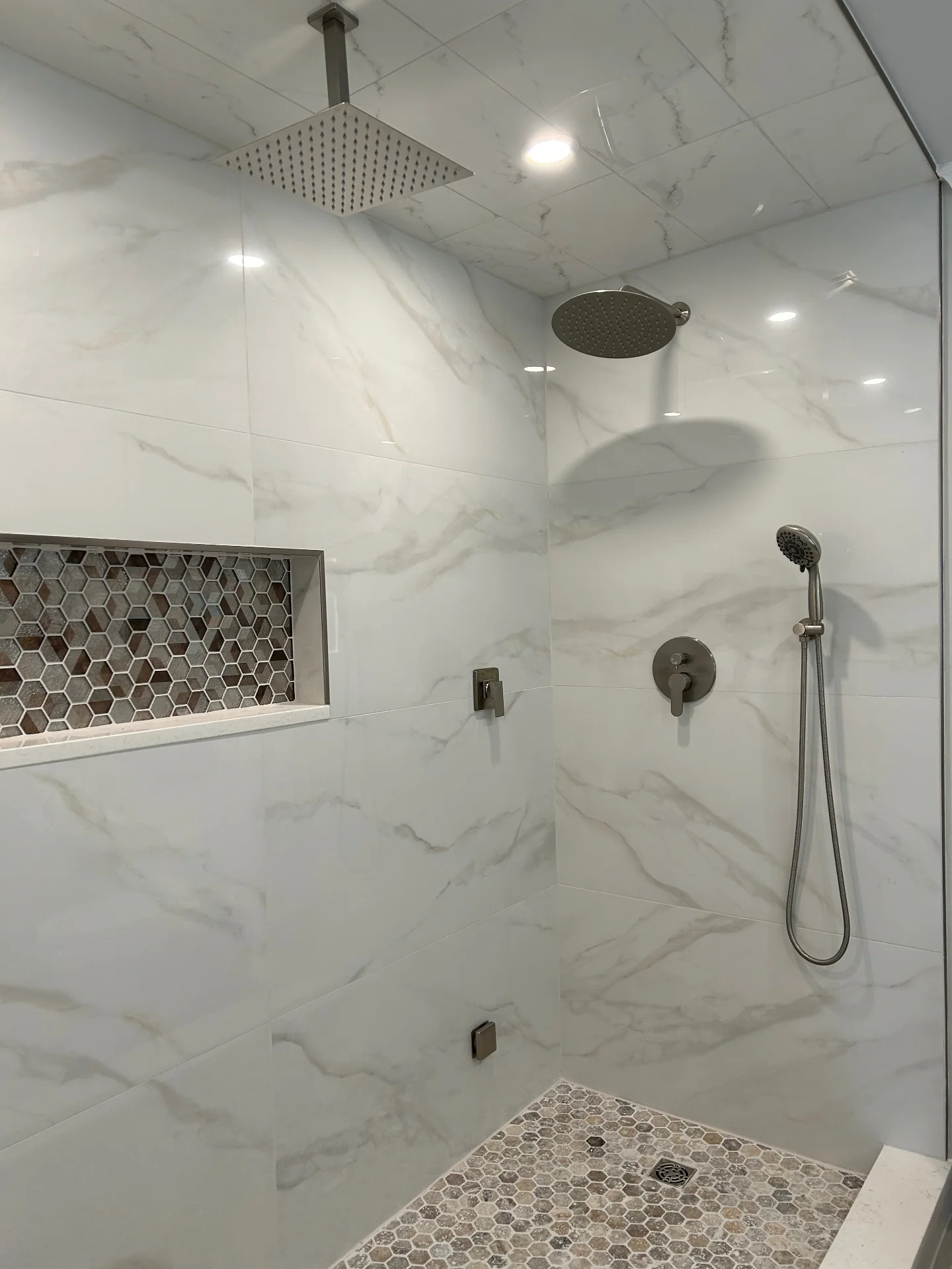 Custom marble walk-in shower with frameless glass in luxury master bathroom renovation NJ by Strong Construction