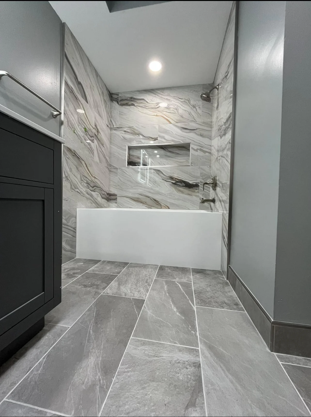 Luxury master bathroom with marble tub surround and custom tile work Rumson NJ