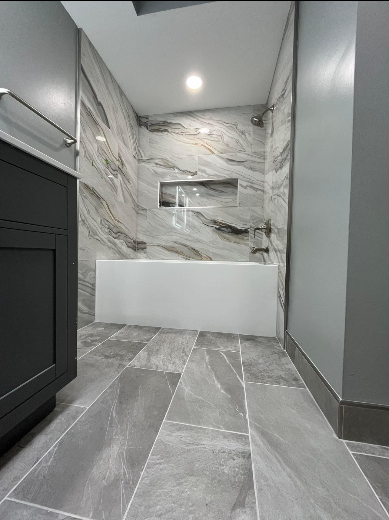 Luxury master bathroom with marble tub surround and custom tile work Rumson NJ